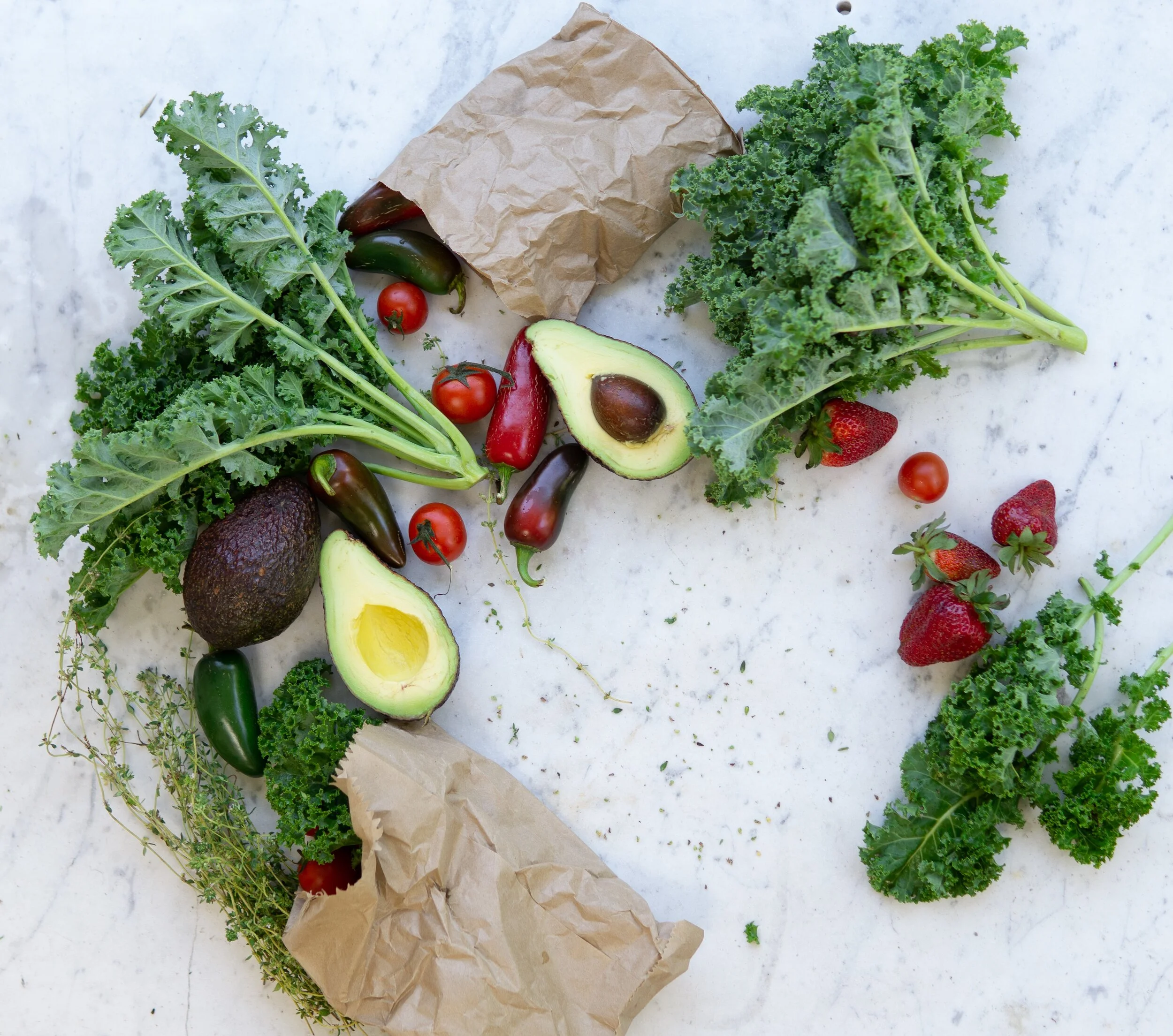 Fresh leafy greens and vegetables on a kitchen surface