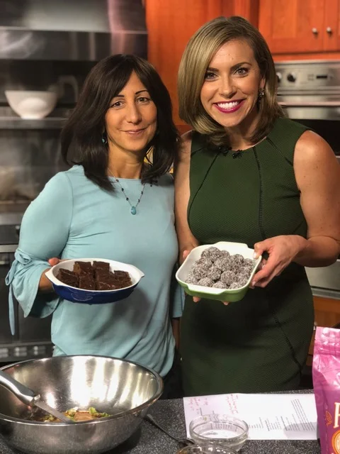 Luisa Szakacs and a television host cooking together
