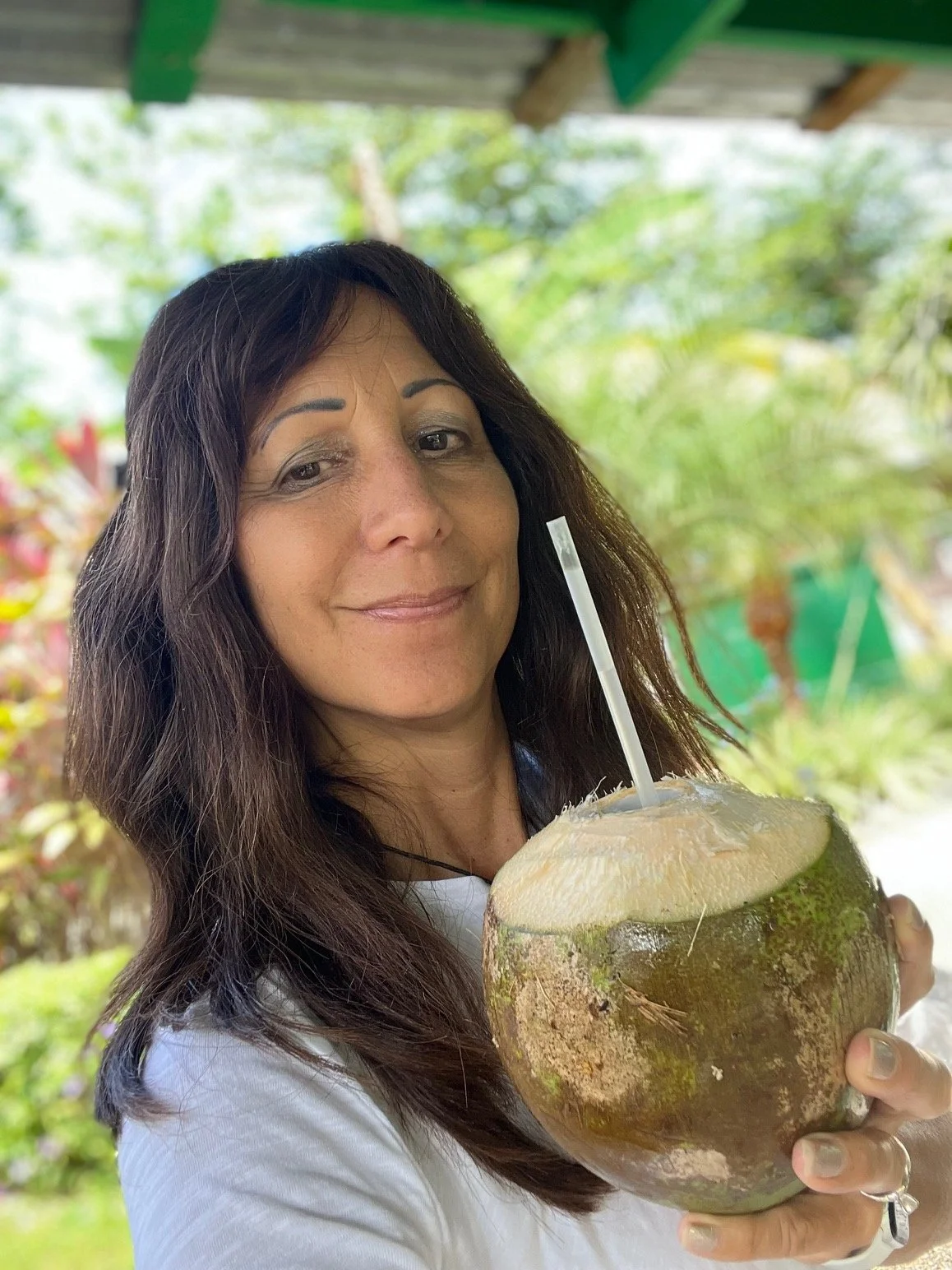 Woman drinking fresh coconut water outdoors